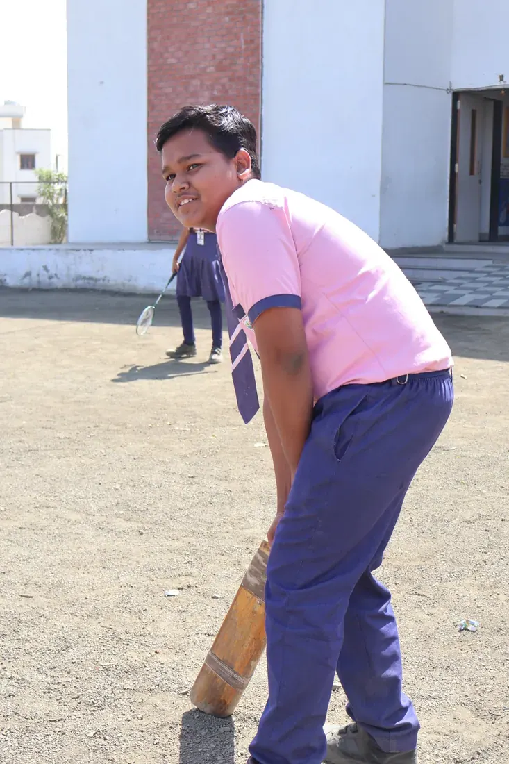 A student playing cricket