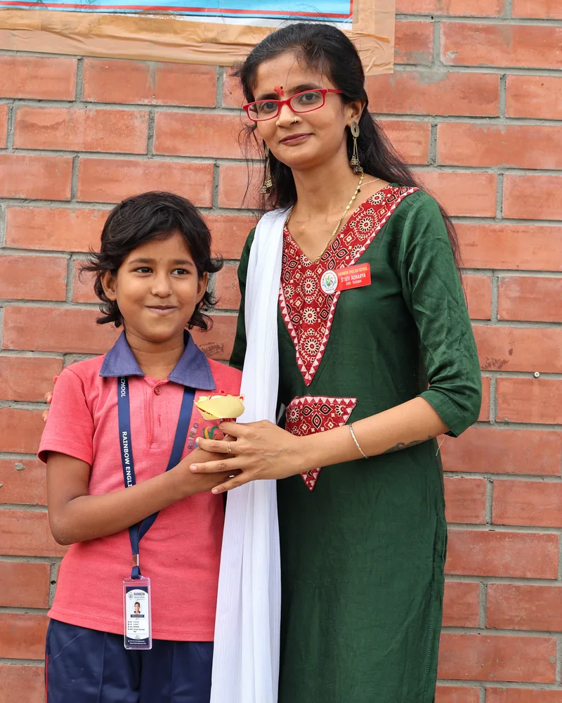 A teacher with a student at Rainbow English School