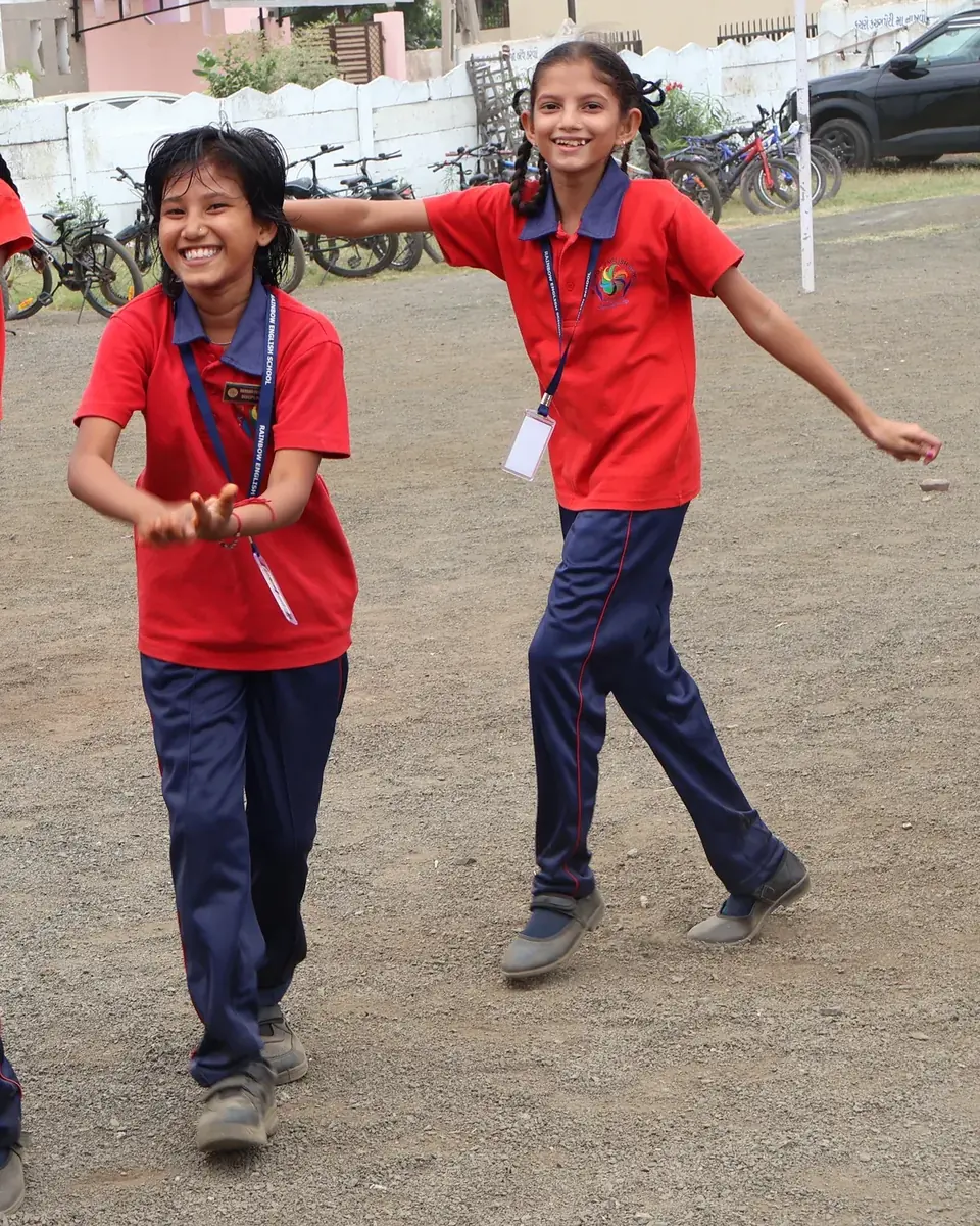 Two students running and laughing outdoors